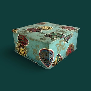 May include: A square, teal-colored box with a decorative pattern of colorful floral designs and paisley motifs. The box is made of cardboard and has a hinged lid.