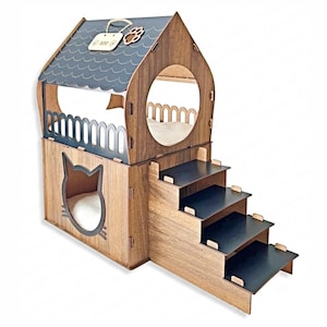 May include: Wooden cat house with a house-shaped design. The cat house has a dark gray roof, a cat-shaped cutout, and a set of steps. The house includes a circular opening and a small sign with a paw print.
