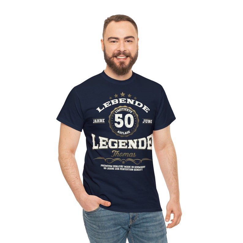 May include: A navy blue t-shirt with a gold graphic that says "LEBENDE 50 JAHRE LIMITIERTE AUFLAGE JUNG LEGENDE Thomas PREMIUM QUALITAT MADE IN GERMANY 50 JAHRE ZUR PERFECTION GERCIFT".