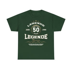 May include: Green t-shirt with a gold design that says "LEBENDE 50 JAHRE AUFLAGE JUNG LEGENDE Thomas PREMIUM QUALITAT MADE IN GERMANY 50 JAHRE ZUR PERFEXTION GEREIFT"