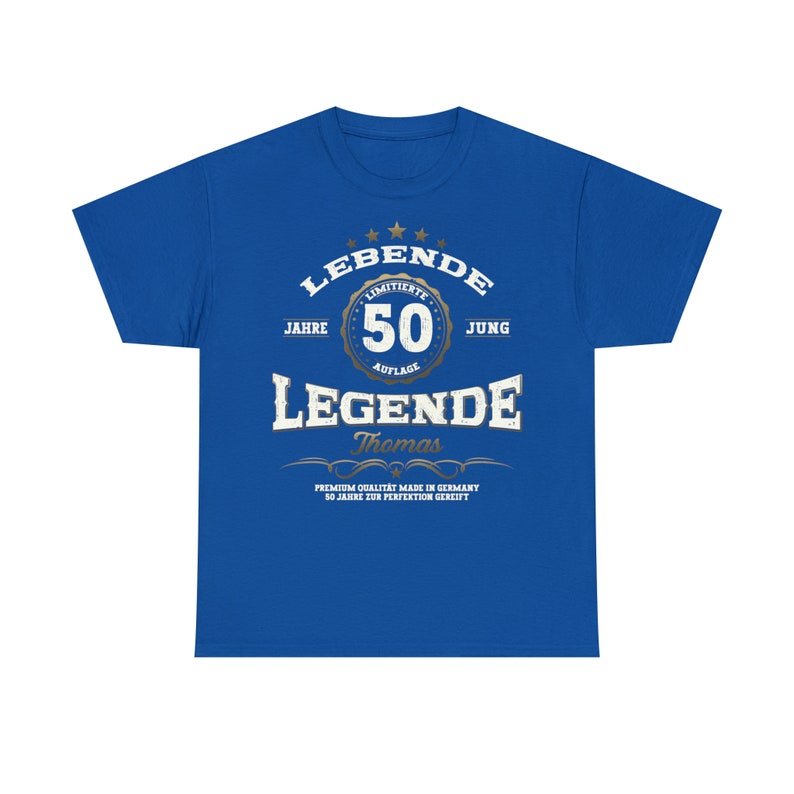 May include: A royal blue t-shirt with a gold and white graphic design that says "LEBENDE 50 JAHRE AUFLAGE JUNG LEGENDE Thomas PREMIUM QUALITAT MADE IN GERMANY 50 JAHRE ZUR PERFEXTION GEREIFT".
