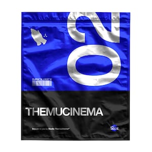 May include: A blue and black foil pouch with the number 20 printed in white. The pouch has the text "THEMUCINEMA" printed in white on a black background. The pouch also has the text "Brought to you by Studio Themucinema" and "12oz" printed in white on a black background.