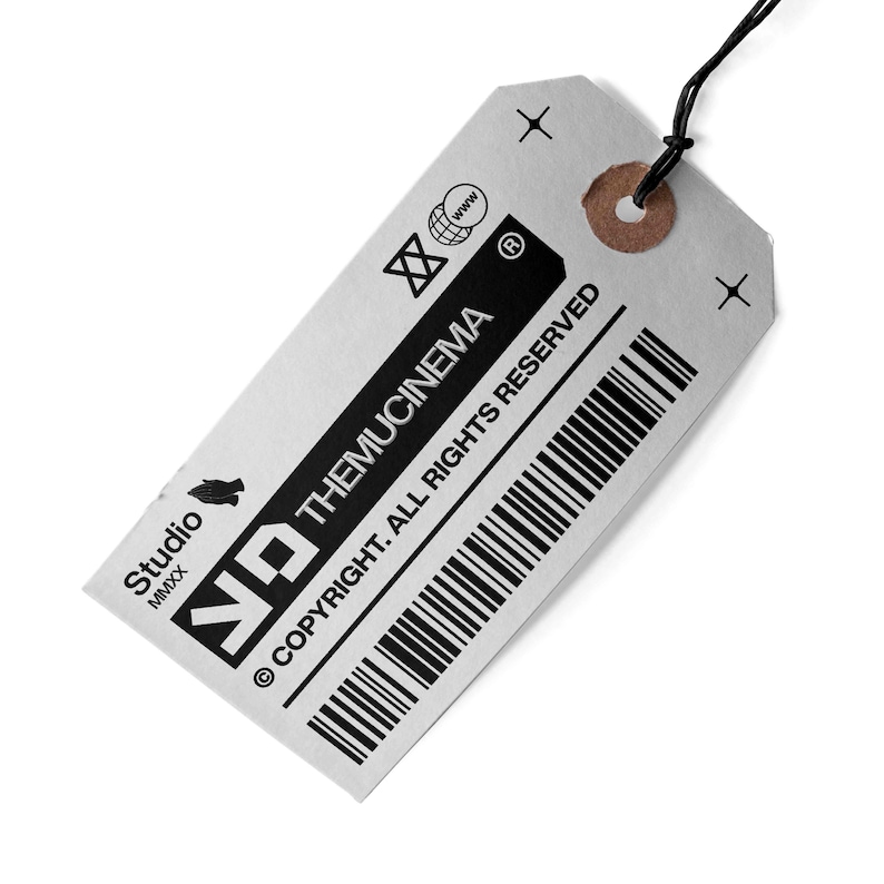 May include: A silver tag with black text that reads "ND THEMUCINEMA &copy; COPYRIGHT. ALL RIGHTS RESERVED" and a barcode. The tag has a small hole at the top and a black string attached.