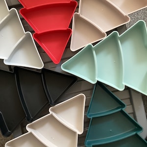 May include: Set of six Christmas tree-shaped serving dishes in various colours, including red, green, black, and white.