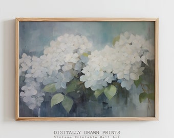 Puede incluir: Una impresión enmarcada que presenta una pintura de flores de hortensia blancas con hojas verdes sobre un fondo azul y gris. El marco es de madera clara. El texto "DIGITALLY DRAWN PRINTS Vintage Printable Wall Art" está en la parte inferior.