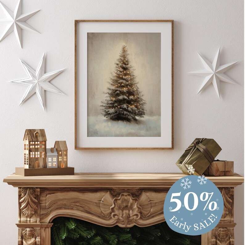 May include: A framed print of a snowy Christmas tree with lights, displayed on a wooden mantel with a small wooden house figurine and a gift wrapped in brown paper. A blue circle with snowflakes and the text "50% Early SALE!" is in the foreground.