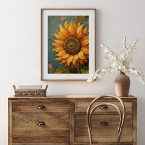 K&ouml;nnte beinhalten: Ein gerahmtes Gem&auml;lde einer einzelnen Sonnenblume mit gelben Bl&uuml;tenbl&auml;ttern und einer braunen Mitte vor blauem Hintergrund.