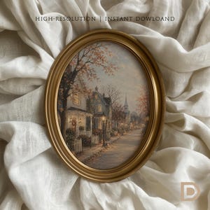 May include: An oval gold frame containing a painting of a quiet street scene with houses, trees, and a church steeple at dusk. The text HIGH-RESOLUTION | INSTANT DOWLOAD is visible at the top, and a letter D logo is in the bottom right corner.