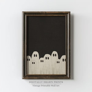 May include: A framed print featuring a black background with a row of white ghost figures at the bottom. The ghosts have simple, oval-shaped bodies and dark eye details. The frame is dark brown. Text at the bottom reads "DIGITALLY DRAWN PRINTS Vintage Printable Wall Art."