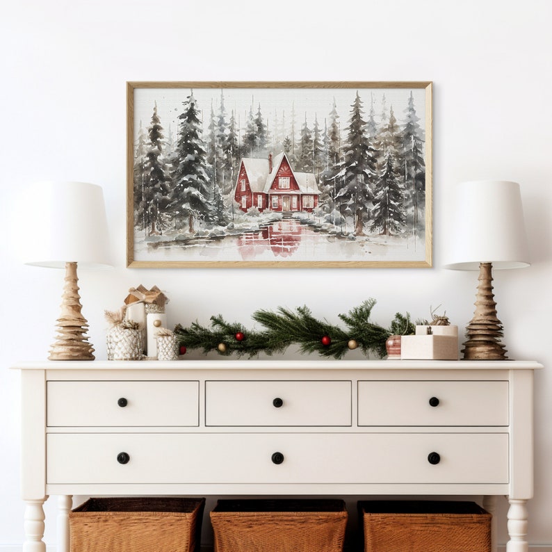 May include: A watercolor painting of a red cabin in a snowy forest. The cabin has a white roof and is surrounded by tall pine trees. The scene is reflected in a lake in front of the cabin.