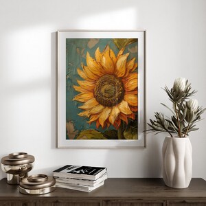 K&ouml;nnte beinhalten: Ein gerahmtes Gem&auml;lde einer Sonnenblume mit gelben Bl&uuml;tenbl&auml;ttern und einer braunen Mitte. Die Sonnenblume ist auf einem blauen und gr&uuml;nen Hintergrund gemalt.