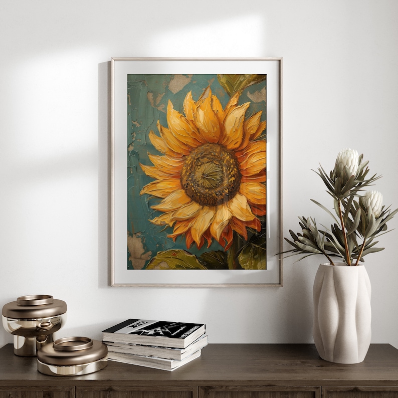K&ouml;nnte beinhalten: Ein gerahmtes Gem&auml;lde einer Sonnenblume mit gelben Bl&uuml;tenbl&auml;ttern und einer braunen Mitte. Die Sonnenblume ist auf einem blauen und gr&uuml;nen Hintergrund gemalt.