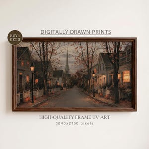 May include: A framed digital print featuring a street scene at dusk with houses, trees, and pumpkins. The text reads: DIGITALLY DRAWN PRINTS, BUY 1 GET 2, HIGH-QUALITY FRAME TV ART, 3840x2160 pixels. The scene includes a church steeple in the distance.