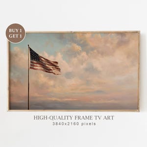May include: Framed artwork featuring an American flag waving in the wind against a backdrop of a pastel-colored sky. The artwork is labeled "HIGH-QUALITY FRAME TV ART" with the resolution of 3840x2160 pixels. A "BUY 1 GET 1" sticker is in the upper left corner.