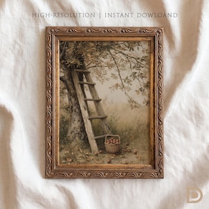 May include: A rectangular wall art print in an ornate gold frame featuring a painting of a wooden ladder leaning against a tree in an orchard with a woven basket of apples on the ground. The text HIGH-RESOLUTION | INSTANT DOWLOAD is visible.