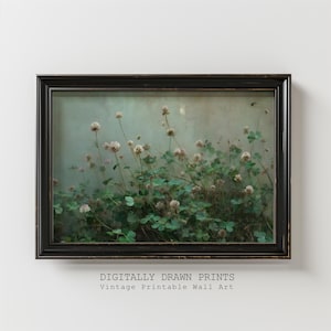 May include: A framed vintage print featuring a field of clover with white flowers and green leaves. The artwork is set against a muted green background and framed in a black, distressed-look frame. Text at the bottom reads "DIGITALLY DRAWN PRINTS Vintage Printable Wall Art."