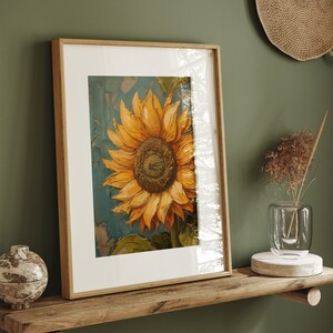 K&ouml;nnte beinhalten: Ein gerahmtes Gem&auml;lde einer Sonnenblume mit gelben Bl&uuml;tenbl&auml;ttern und einer braunen Mitte. Die Sonnenblume ist auf einem blauen Hintergrund mit einem strukturierten Effekt gemalt. Der Rahmen ist aus Holz und hat eine hellbraune Oberfl&auml;che.