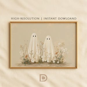 May include: A rectangular wall art print in a gold frame featuring two white ghost figures draped in sheets standing amidst a field of wildflowers in neutral beige tones. The text HIGH-RESOLUTION | INSTANT DOWLOAND is printed above the artwork.