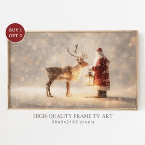 May include: A framed digital art print depicts Santa Claus holding a lantern, standing in a snowy landscape with a reindeer. The artwork has a vintage aesthetic, with soft lighting and a warm color palette. Text at the bottom reads "HIGH-QUALITY FRAME TV ART".