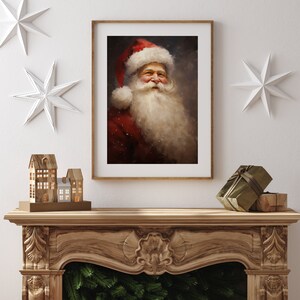 May include: A framed print of Santa Claus in a red suit and hat with a long white beard. The artwork is displayed above a wooden fireplace mantel decorated with Christmas ornaments and a gift box.