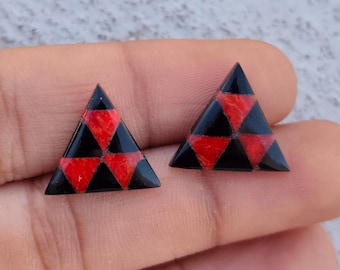 May include: A pair of triangular earrings with a black and red geometric pattern.