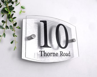 May include: Silver house number sign with a clear acrylic overlay. The number 10 is printed in black with the street name "Thorne Road" printed below.