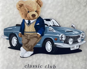 May include: A brown teddy bear wearing a blue blazer, a beige sweater, and khaki pants is leaning against a blue vintage car. The car has a license plate that reads "ABC 111 California". The image has the text "classic club" at the bottom.
