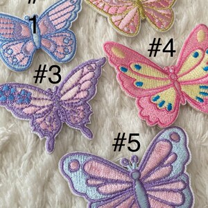 May include: Five embroidered butterfly patches in various colours, including pink, purple, blue, and yellow. The patches are numbered 1 through 5.