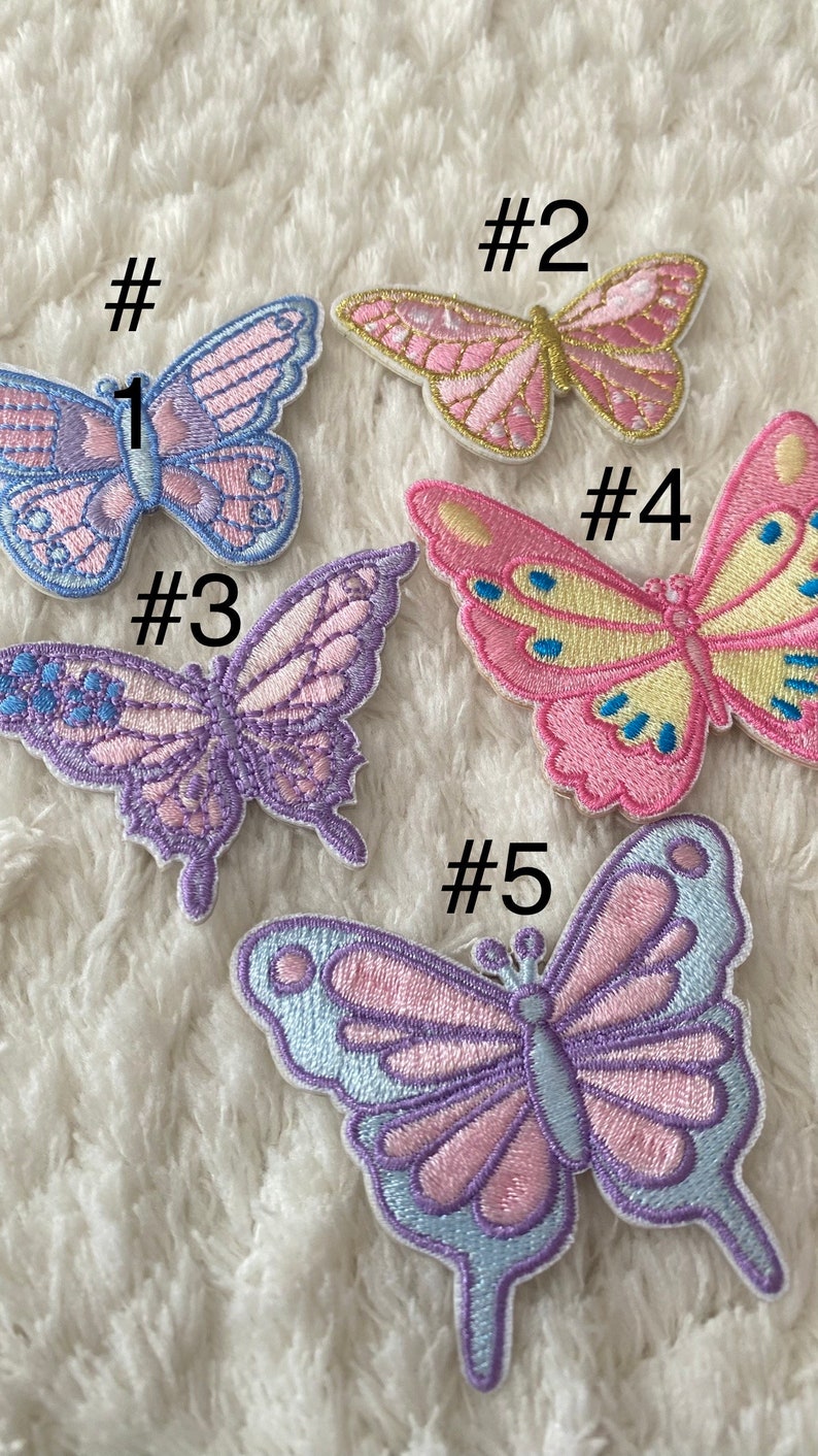 May include: Five embroidered butterfly patches in various colours, including pink, purple, blue, and yellow. The patches are numbered 1 through 5.