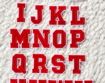 May include: Red felt letter patches with white outlines, featuring the entire alphabet from A to Z.
