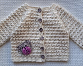 Baby's cream cardigan with teddy bear motif. 0 - 3 months.