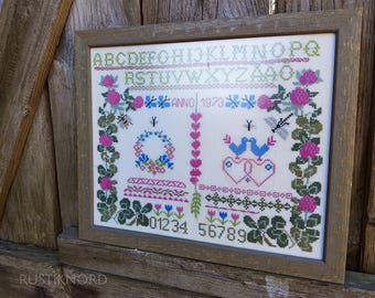 Vintage Swedish hand embroidered sampler.Framed.Dated 1973