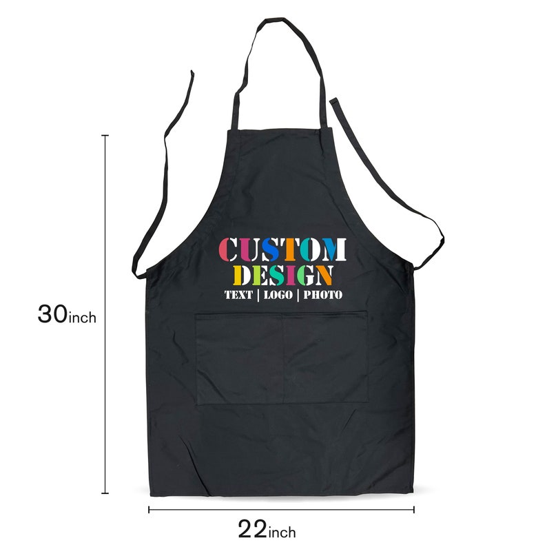 May include: Black apron with a large pocket and adjustable straps. The apron has the text "CUSTOM DESIGN TEXT | LOGO | PHOTO" printed on the front in colorful letters.