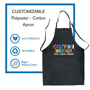 May include: Black polyester and cotton apron with a large pocket and adjustable straps. The apron has the text "CUSTOM DESIGN TEXT | LOGO | PHOTO" printed on the front in colorful letters.
