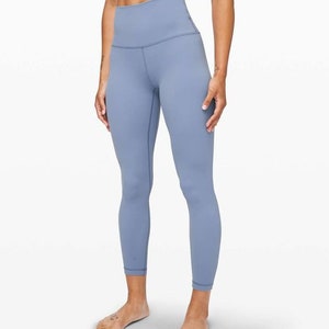 May include: A pair of light blue leggings with a high waist and a fitted silhouette.