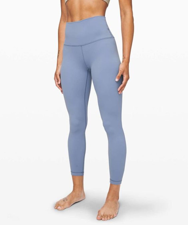 May include: A pair of light blue leggings with a high waist and a fitted silhouette.