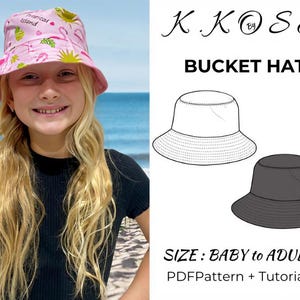 May include: A pink bucket hat with a tropical island print, worn by a person with long blonde hair. The hat has a light pink brim and a white interior. The image also includes a line drawing of a bucket hat and the text "BUCKET HAT".