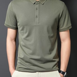 May include: A green short-sleeved polo shirt with a button-up collar.