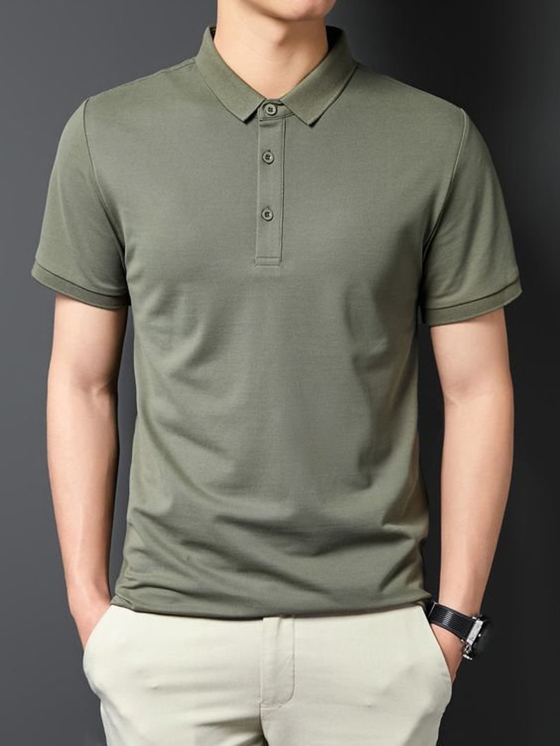 May include: A green short-sleeved polo shirt with a button-up collar.