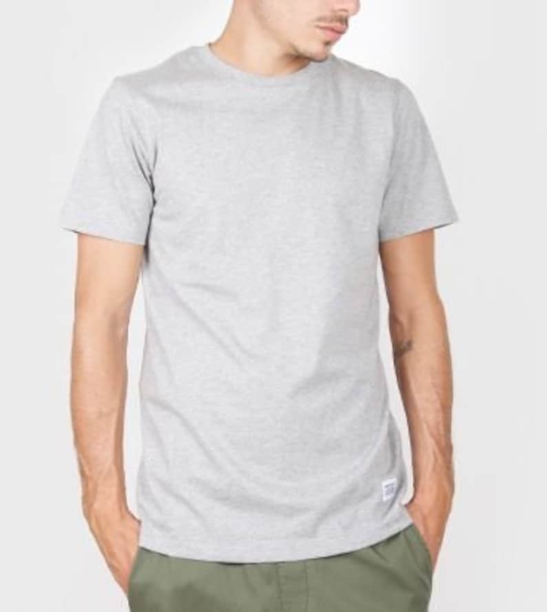 May include: A heather grey short-sleeved t-shirt with a crew neck.