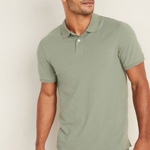 May include: A green short-sleeved polo shirt with a button-up collar.