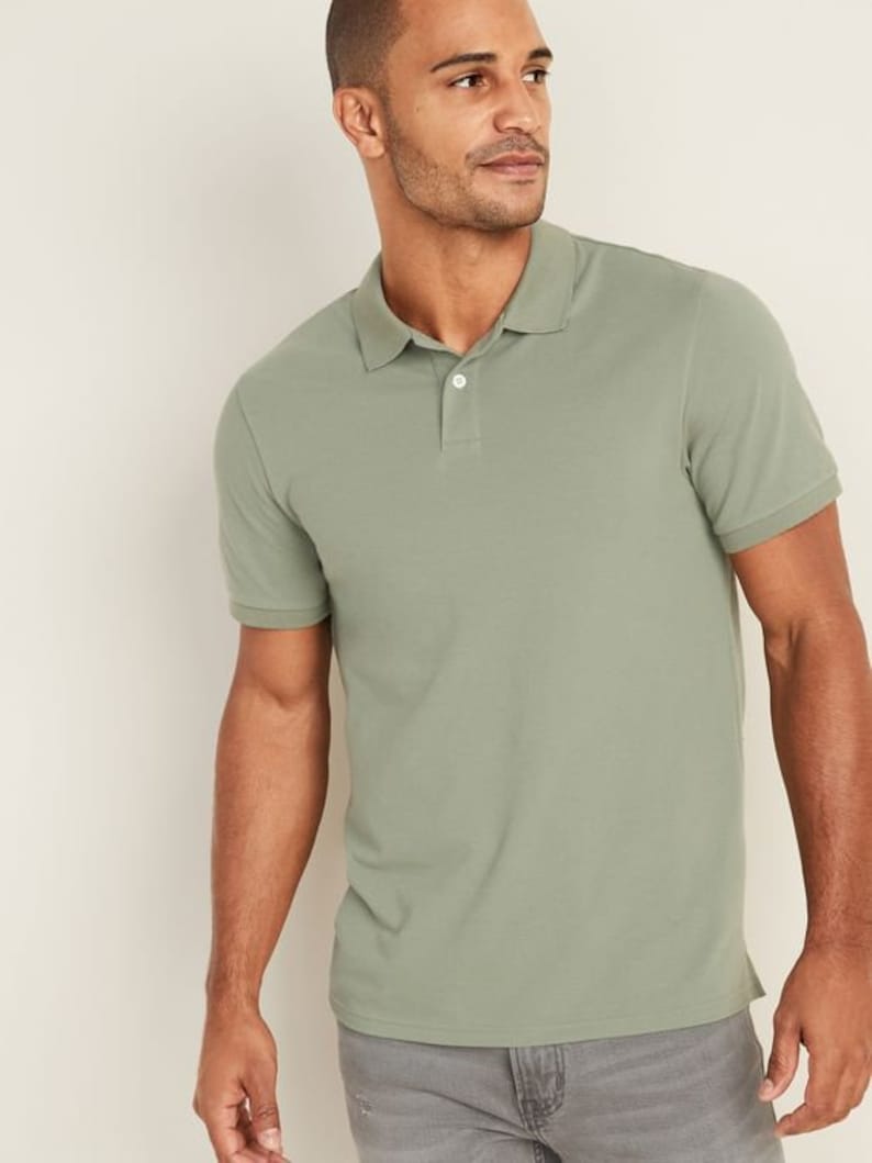 May include: A green short-sleeved polo shirt with a button-up collar.