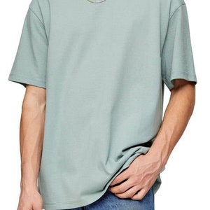 May include: A light blue t-shirt with a short sleeve and a crew neck. The t-shirt is made of a soft, comfortable fabric and has a relaxed fit.