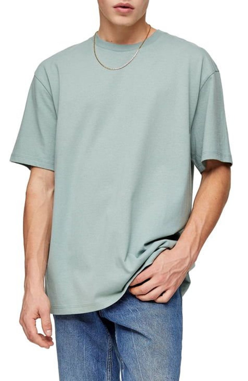 May include: A light blue t-shirt with a short sleeve and a crew neck. The t-shirt is made of a soft, comfortable fabric and has a relaxed fit.