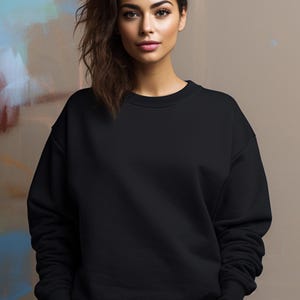 May include: A black sweatshirt with long sleeves and a crew neck.