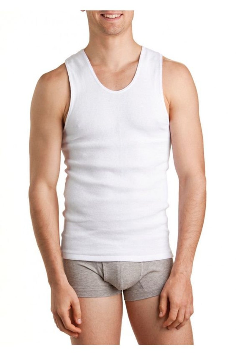 May include: A white sleeveless undershirt with a ribbed texture. The undershirt is made of a soft, comfortable material.