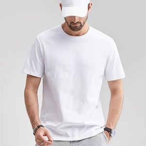 May include: A white short-sleeved t-shirt with a crew neck. The person is wearing a white baseball cap.