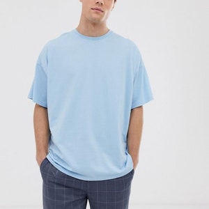 May include: An oversized light blue t-shirt with a crew neck.