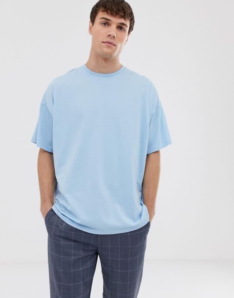 May include: An oversized light blue t-shirt with a crew neck.