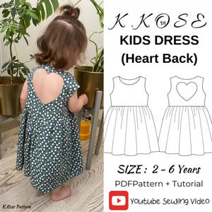 May include: A young child wearing a green dress with a heart-shaped cutout on the back. The dress has a pattern of white hearts. The image also shows a line drawing of the dress and text that reads "KIDS DRESS (Heart Back)" and "SIZE: 2-6 Years".